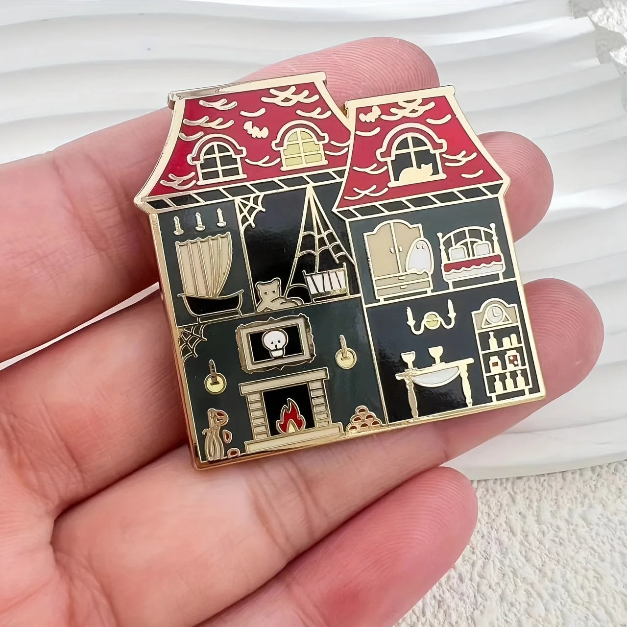 Pin with a design of a haunted house and its interior 